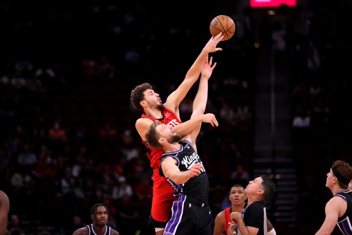 Rockets center Alperen Sengun (28) and Sacramento Kings forward Domantas Sabonis (10) leap for the opening jump ball during the first quarter at Toyota Center.